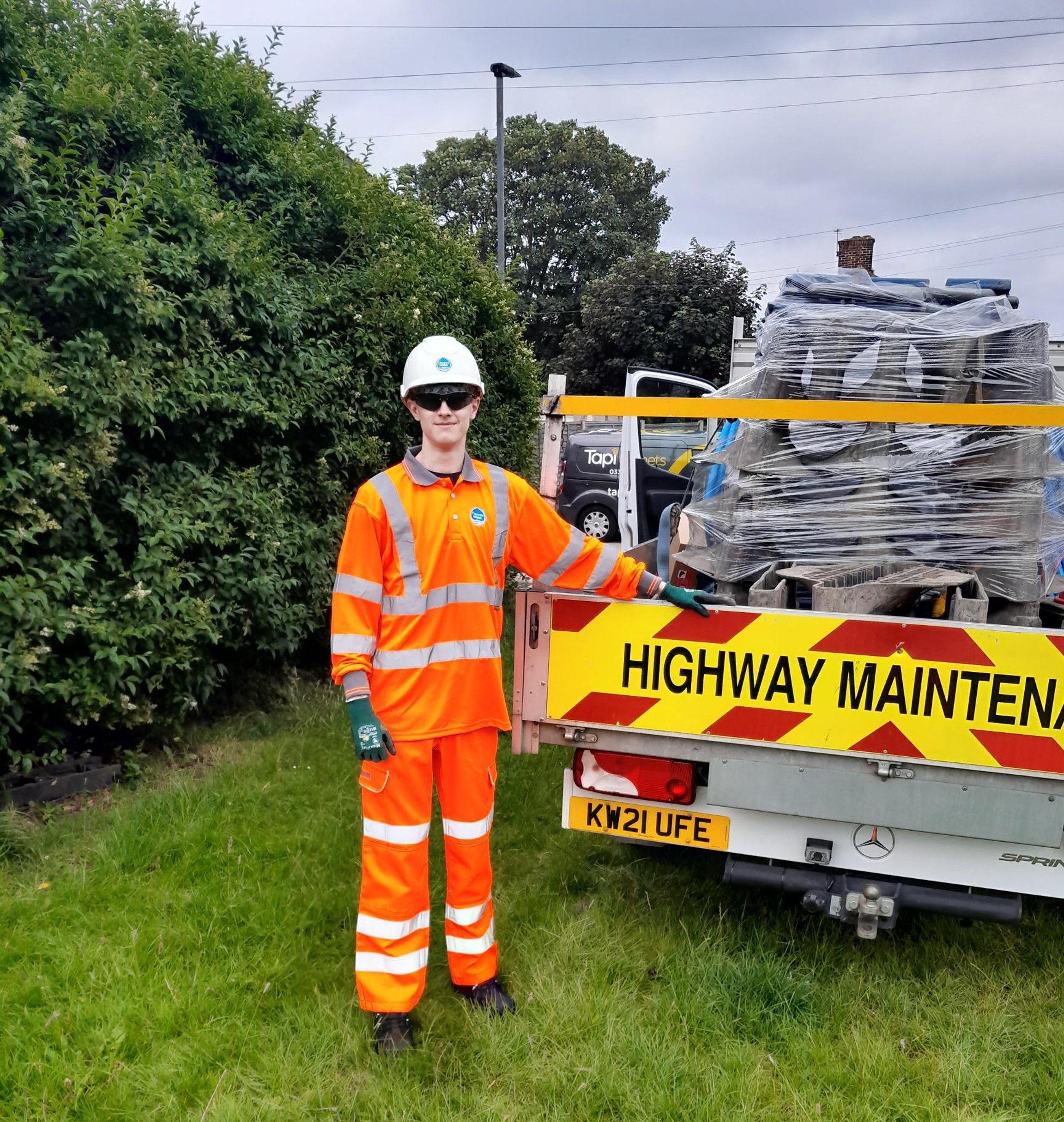 Browne Group - A highway worker in orange safety gear stands by a 